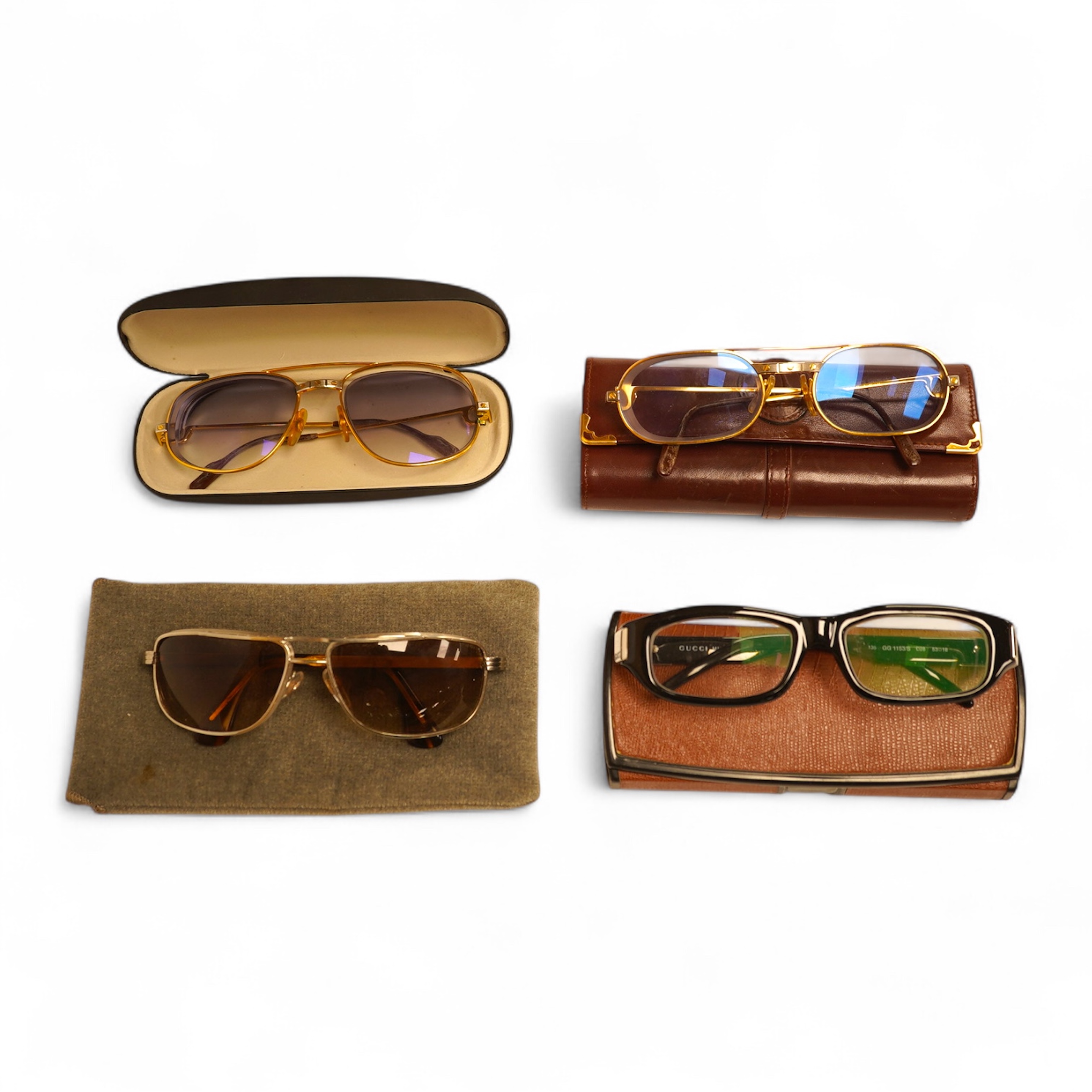 Two pairs of vintage Cartier gilt metal glasses, a pair of Gucci glasses and another